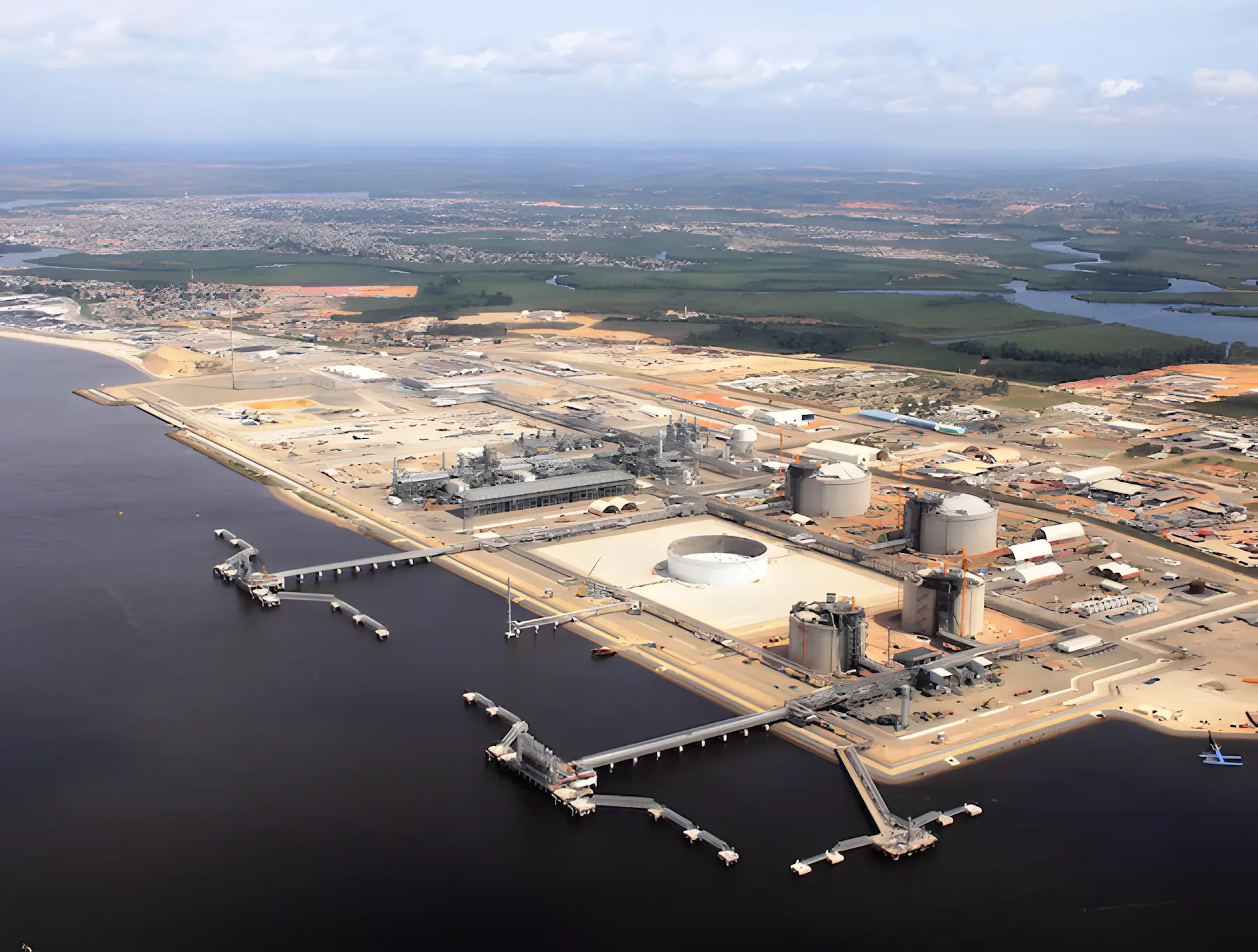 Vue aérienne de l’usine Angola LNG et de ses appontements sur la rive du fleuve, à Soyo, avec la ville en arrière-plan